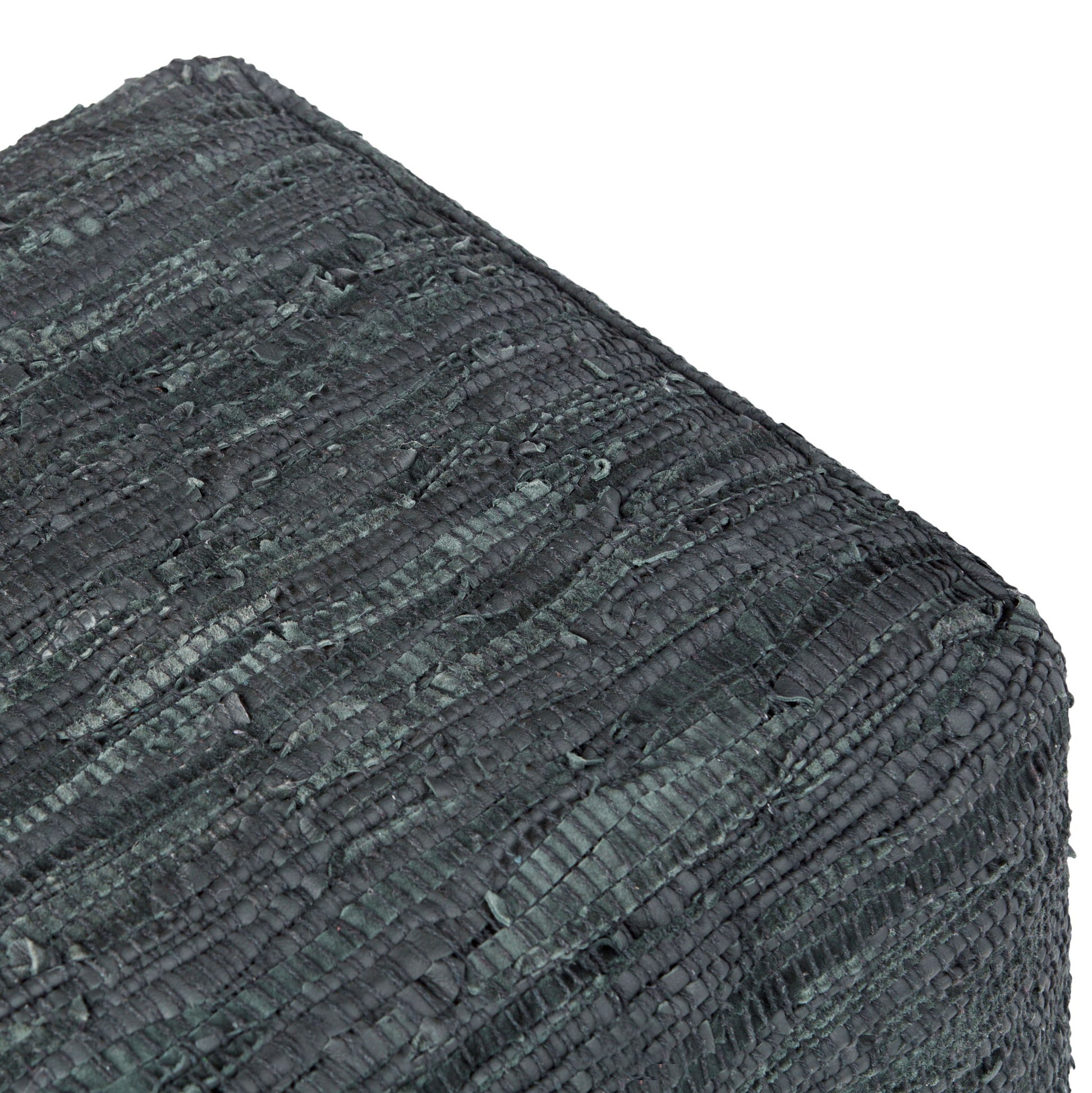 Close-up of the Fredrik - Handcrafted Square Pouf in dark gray, featuring a textured, woven pattern and showing its corner detail.