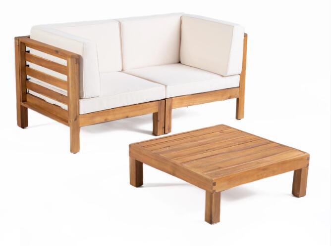 The Oana - 3 Piece Love Seat Set With Coffee Table features a wooden outdoor sectional sofa with white cushions and a matching low wooden coffee table, all shown against a plain white background.