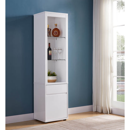 The Modern Wine Showcasing Cabinet with two glass shelves and storage displays bottles, glasses, and a plant. It stands tall in white against a blue wall by a large window with sheer white curtains, allowing plenty of natural light.