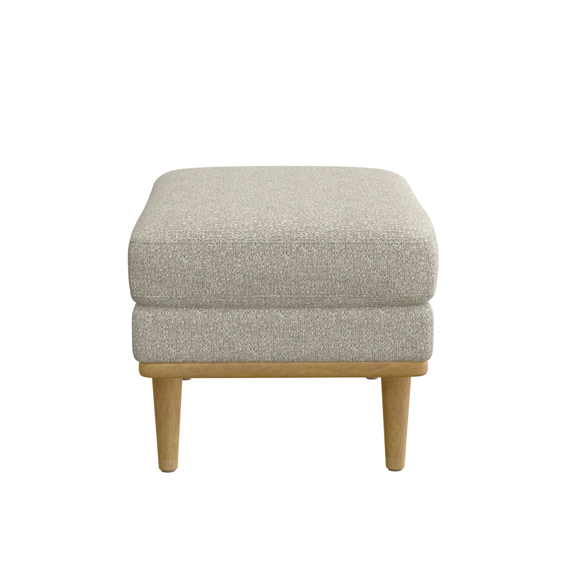 The Revel Chair Ottoman in tan is a square, upholstered piece with wooden legs, shown from the front against a white background.