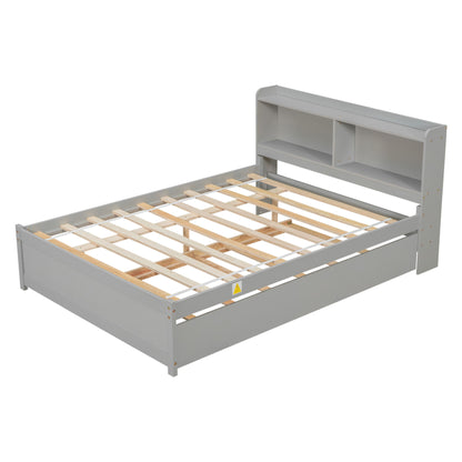 A gray wooden Full Bed with Trundle and Bookcase features a slatted base and a headboard with two open storage shelves. Shown without mattress.