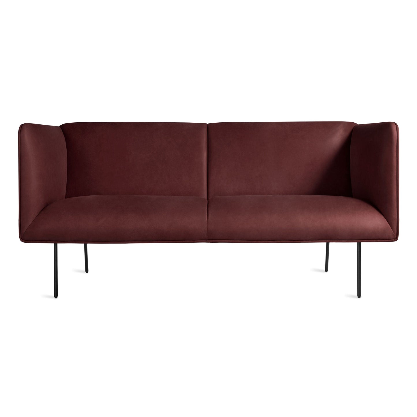 The Dandy Leather Studio Sofa in oxblood leather features a modern, minimalist design with high arms and slim black metal legs, shown against a plain white background.