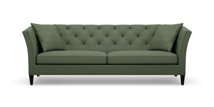 Introducing the Shelton 98" Sofa: a green tufted masterpiece accompanied by two matching cushions. This design boasts high arms and a sleek, modern aesthetic, complete with dark wooden legs and a cozy, plush appearance.