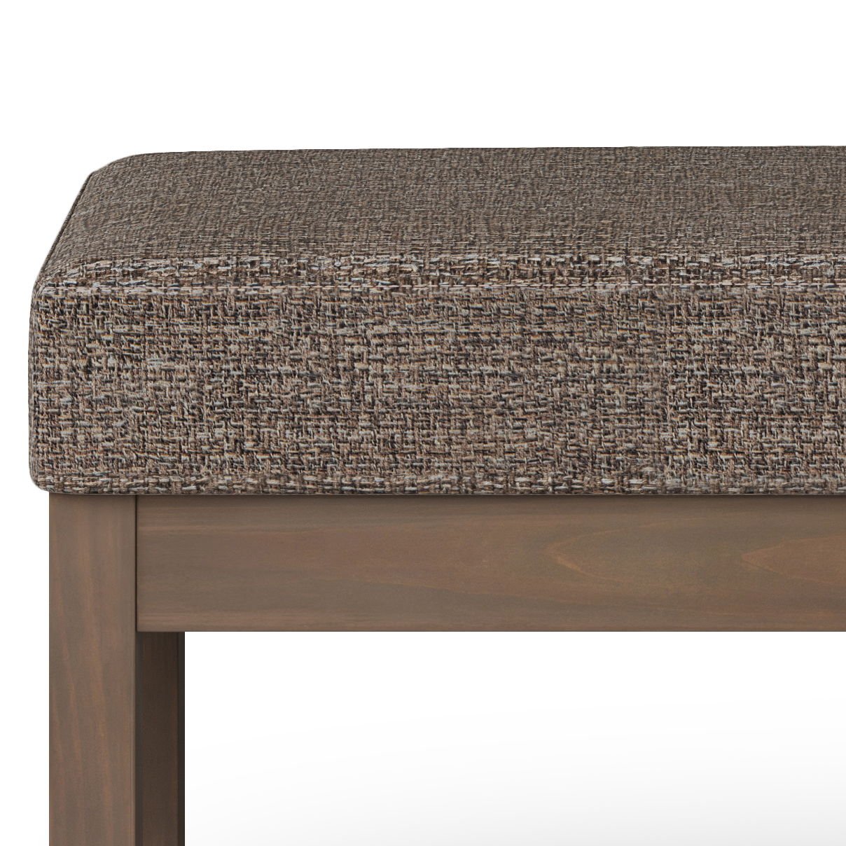 A close-up of the Milltown Upholstered Ottoman Bench, showcasing its textured brown cushion and wooden frame with straight legs and a rectangular design.