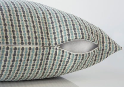 A close-up of a Square Decorative Throw Pillow with a blue, gray, and beige checkered pattern and a partially open white zipper, revealing the hypoallergenic insert included.