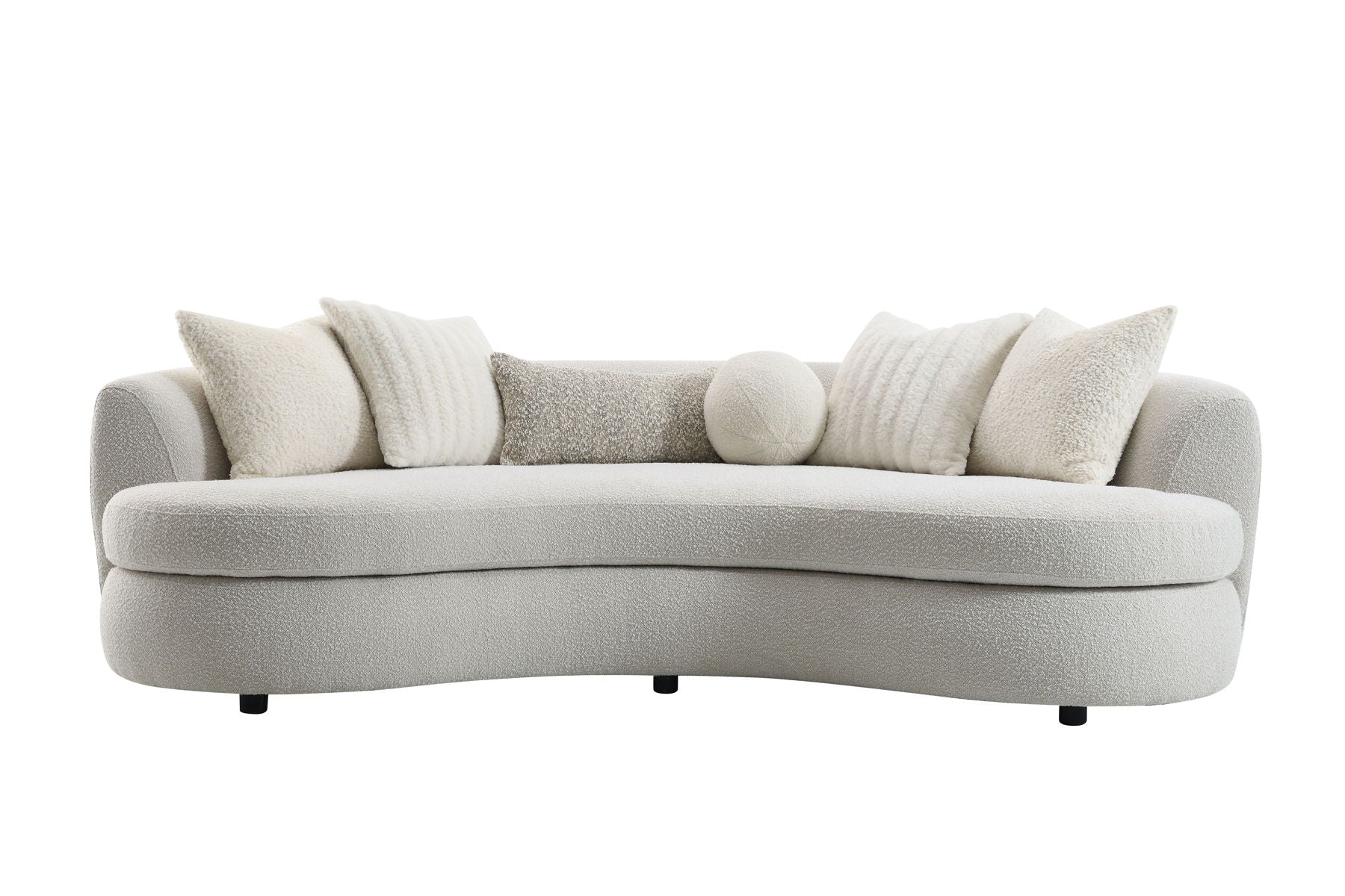 The Couch.com Iniko Boucle Sofa features a modern curved design in beige, comes with four large square and one round toss pillow, all in matching soft textured fabric, plus short black legs for a plush, cozy look and durable construction.
