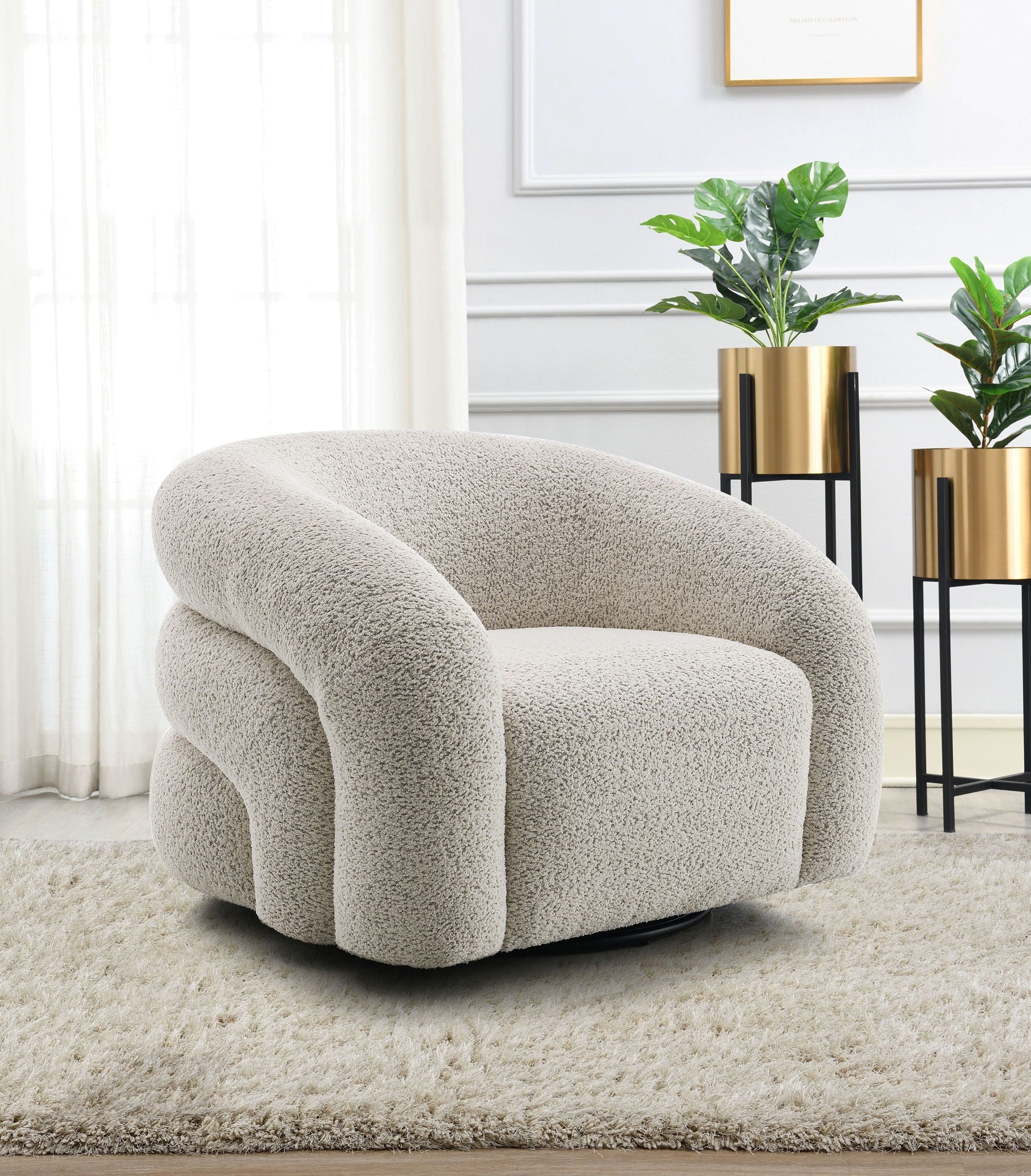 The Irma Chair With Swivel in gray sits on a soft rug in a bright room with large windows, white walls, and two green potted plants in gold planters on black stands in the background.