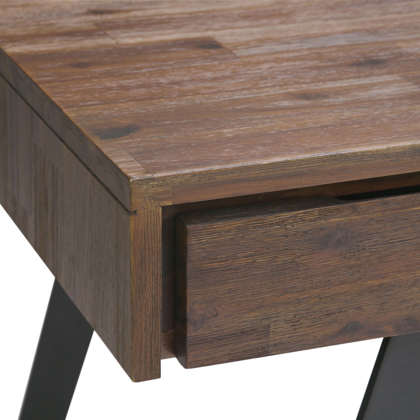 Close-up of the Lowry - Handcrafted Desk’s corner with a partially open drawer. It features a rustic finish, visible wood grain, and sits on angled black metal legs.