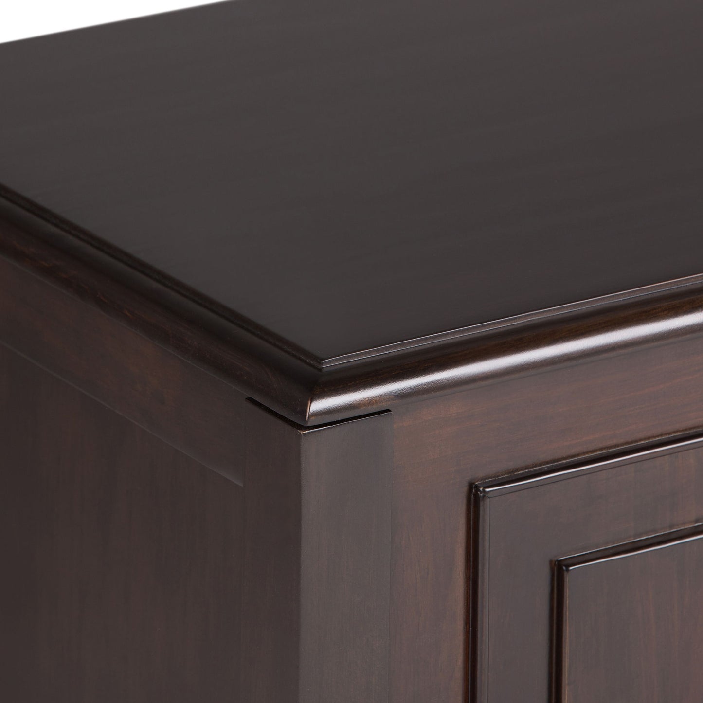 Close-up of the top corner and side of the Connaught - Handcrafted Storage Bench Trunk, showcasing its dark wood, smooth polished finish, and beveled edges.