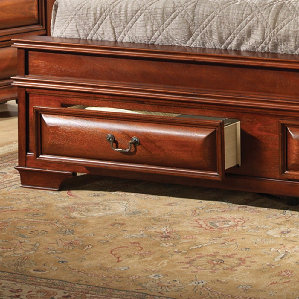 The Lavita - Storage Bed features a partially open drawer at the foot holding a book, complemented by a gray quilted cover and set on a patterned beige rug.