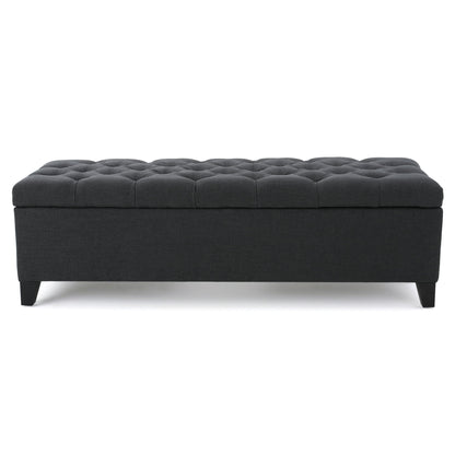 The Glouster Contemporary Storage Ottoman features a rectangular, dark gray button-tufted design with short black legs, displayed against a white background.