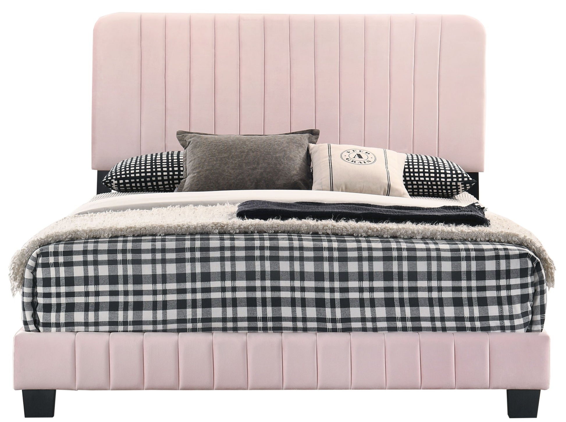 The Lodi - Bed features a modern design with a tall, light pink upholstered headboard and base, paired with black-and-white checkered bedding and decorative pillows in mixed patterns and neutral tones.