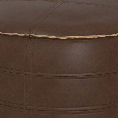 Close-up of the Brody - Round Pouf, featuring brown leather with visible stitching and a seam along the top edge. The leather texture and precise stitch alignment are clearly displayed.