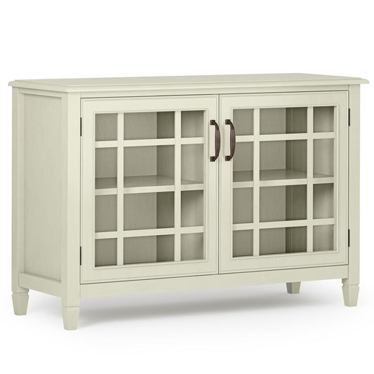The Connaught - Handcrafted Low Storage Cabinet features a light wood finish, two glass-paned doors with a grid design, dark metal handles, interior shelving, and stands on four short legs.