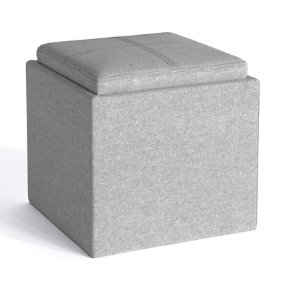 The Rockwood Upholstered Cube Storage Ottoman with Tray is a modern gray square ottoman featuring a cushioned top and shown on a plain white background.