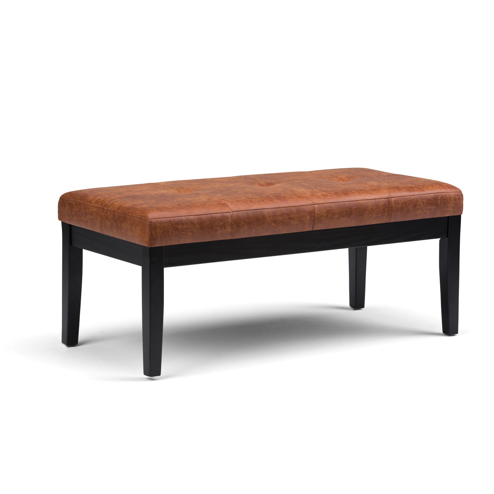 The Lacey Upholstered Tufted Ottoman Bench features a cushioned brown leather seat and four black wooden legs, shown on a white background.