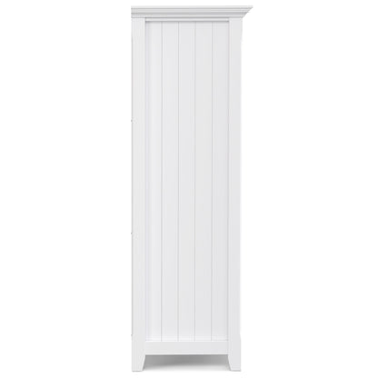 The Acadian - Handcrafted Cube Storage is a tall, white wooden cabinet with vertical panel detailing and a crown molding top, shown from the side.