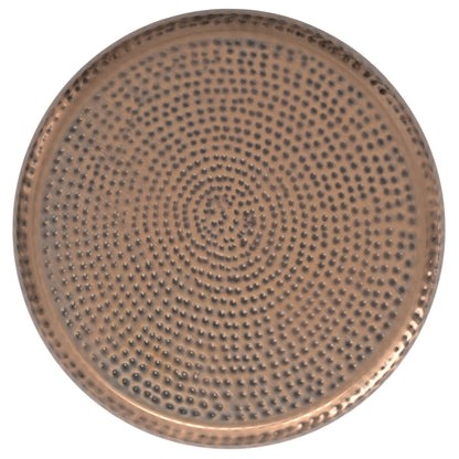 The Preston Handcrafted Metal Side Table features a round, metallic top with a hammered texture and concentric circles of raised dots, shown from above on a white background.