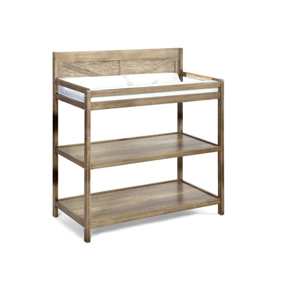 The Barnside - Changing Table Vintage features a rustic light brown wood finish, a raised edge, cushioned changing pad, and two open storage shelves below.