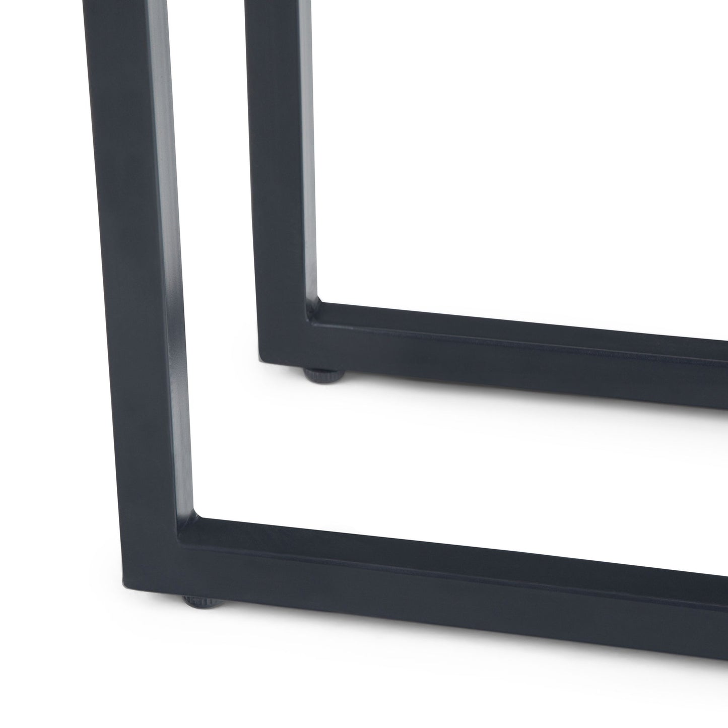 Close-up of the black metal legs of the Skyler - C Side Handcrafted Table on a white background, featuring a modern, rectangular geometric design.
