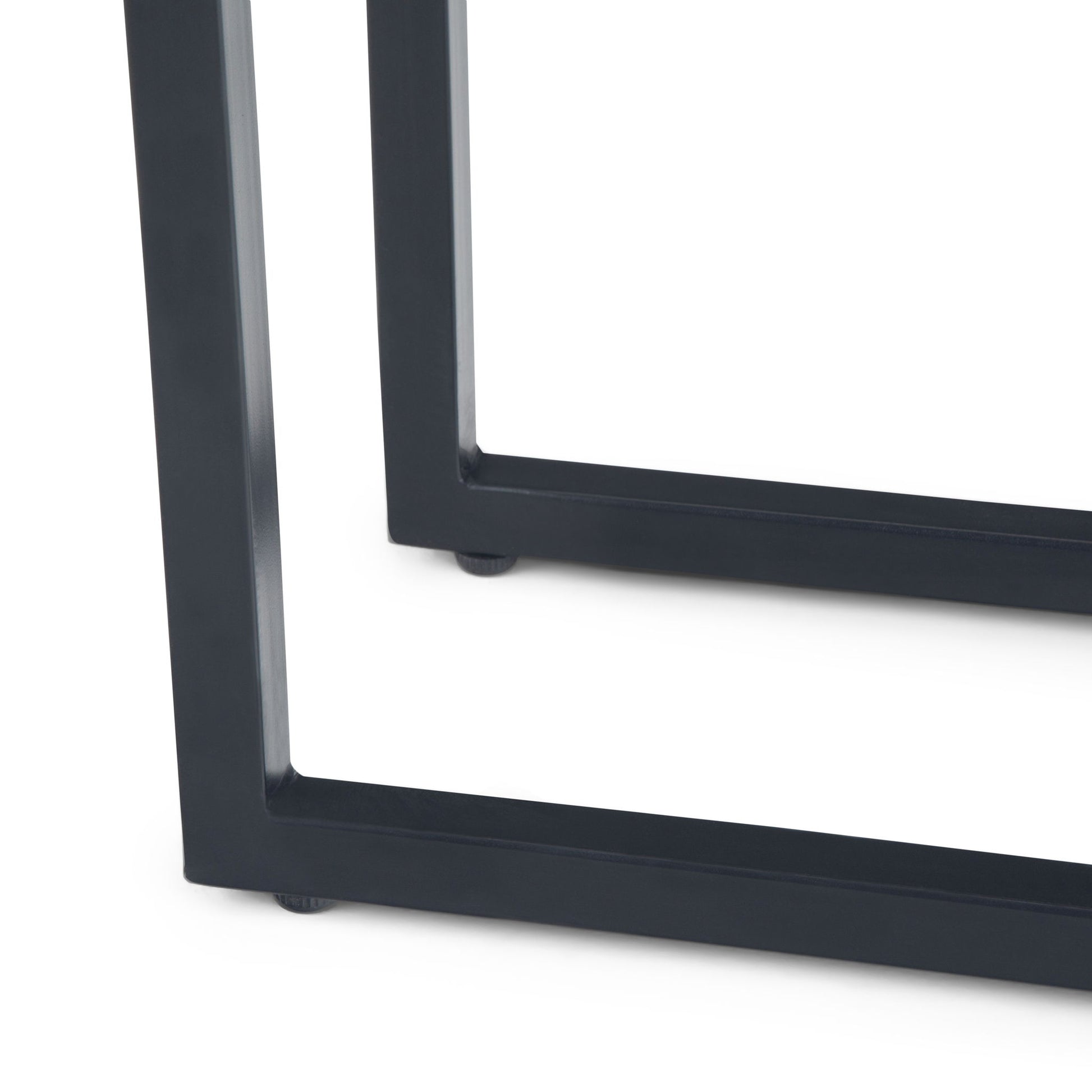 Close-up of the black metal legs of the Skyler - C Side Handcrafted Table on a white background, featuring a modern, rectangular geometric design.