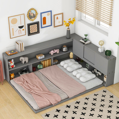 A cozy bedroom corner features the Floor Bed With L-Shaped Bookcases, Sliding Doors, Without Slats, styled with pink and beige bedding, cloud-shaped pillows, toys and decor on the shelves, framed wall art, and a daylight-filled window with blinds.