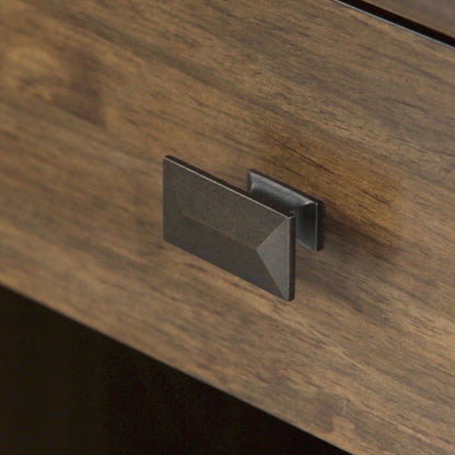 A close-up of the Artisan - Handcrafted Bedside Table shows a rectangular, dark metal pull handle on its wooden surface with a natural brown finish.