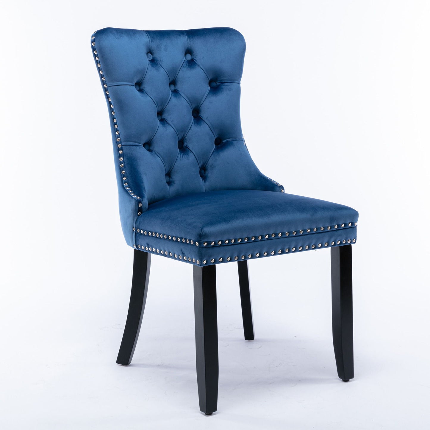 The Nikki set features two modern high-end velvet upholstered dining chairs with tufted backs, silver nailhead trim, and black wood legs, displayed against a plain white background.