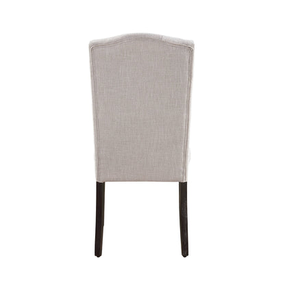 The Gerardo - Linen Weathered Dining Chair (Set of 2) in beige features a light gray upholstered seat, a slightly curved backrest, and dark wooden legs, displayed from the back against a white background.