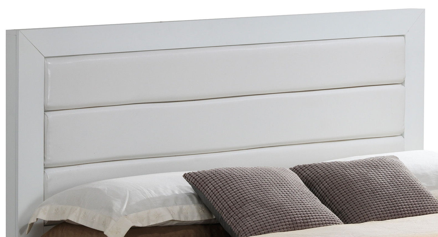 A close-up of the Transitional Modern Design Bed features a modern white headboard with horizontal padded panels, complemented by neatly arranged white pillows and textured gray accent pillows.