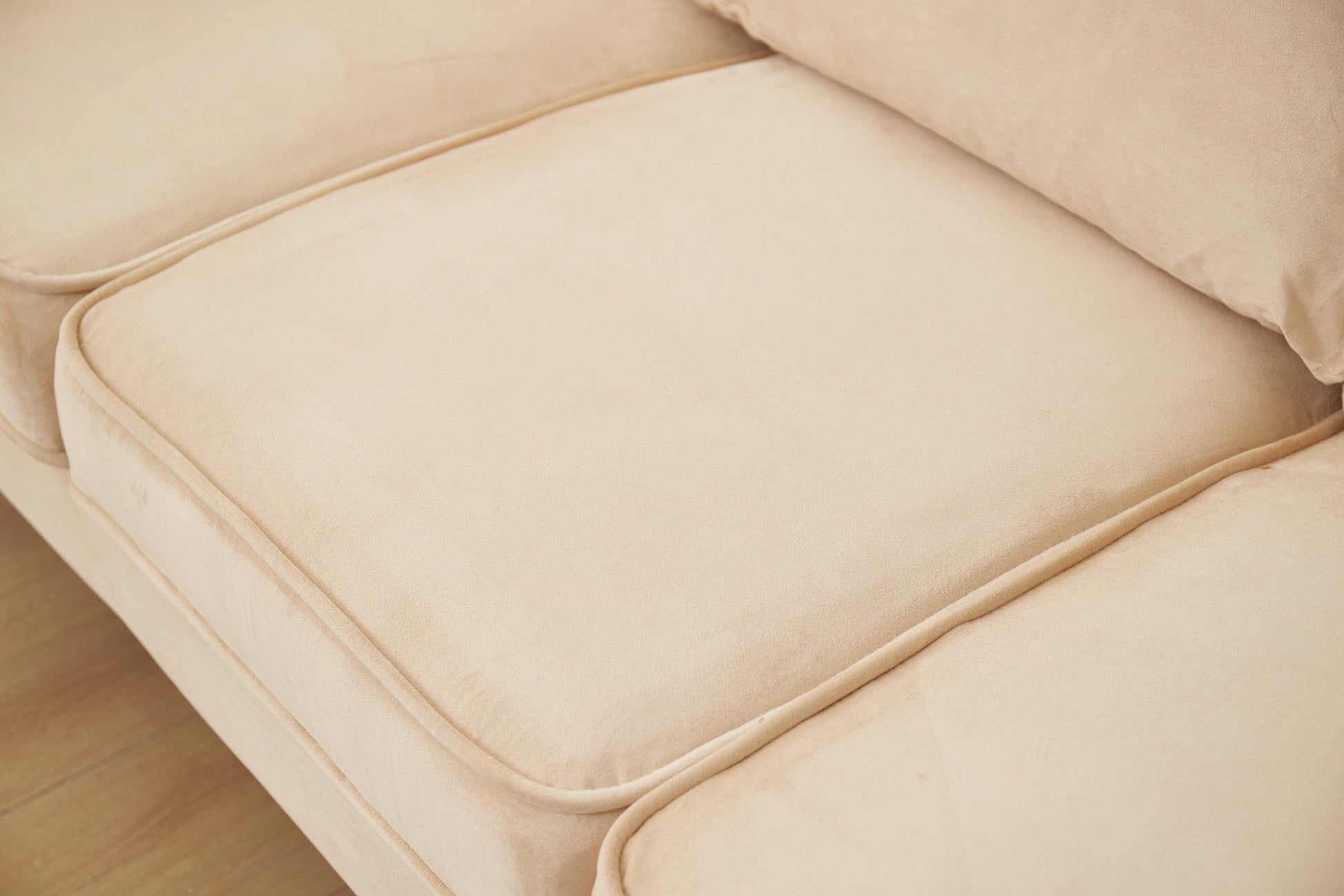 Close-up of the Graceful Design Plush Comfort Sofa in beige, featuring three seat cushions, a back cushion, smooth fabric texture, subtle seam lines, and a clean, simple design.
