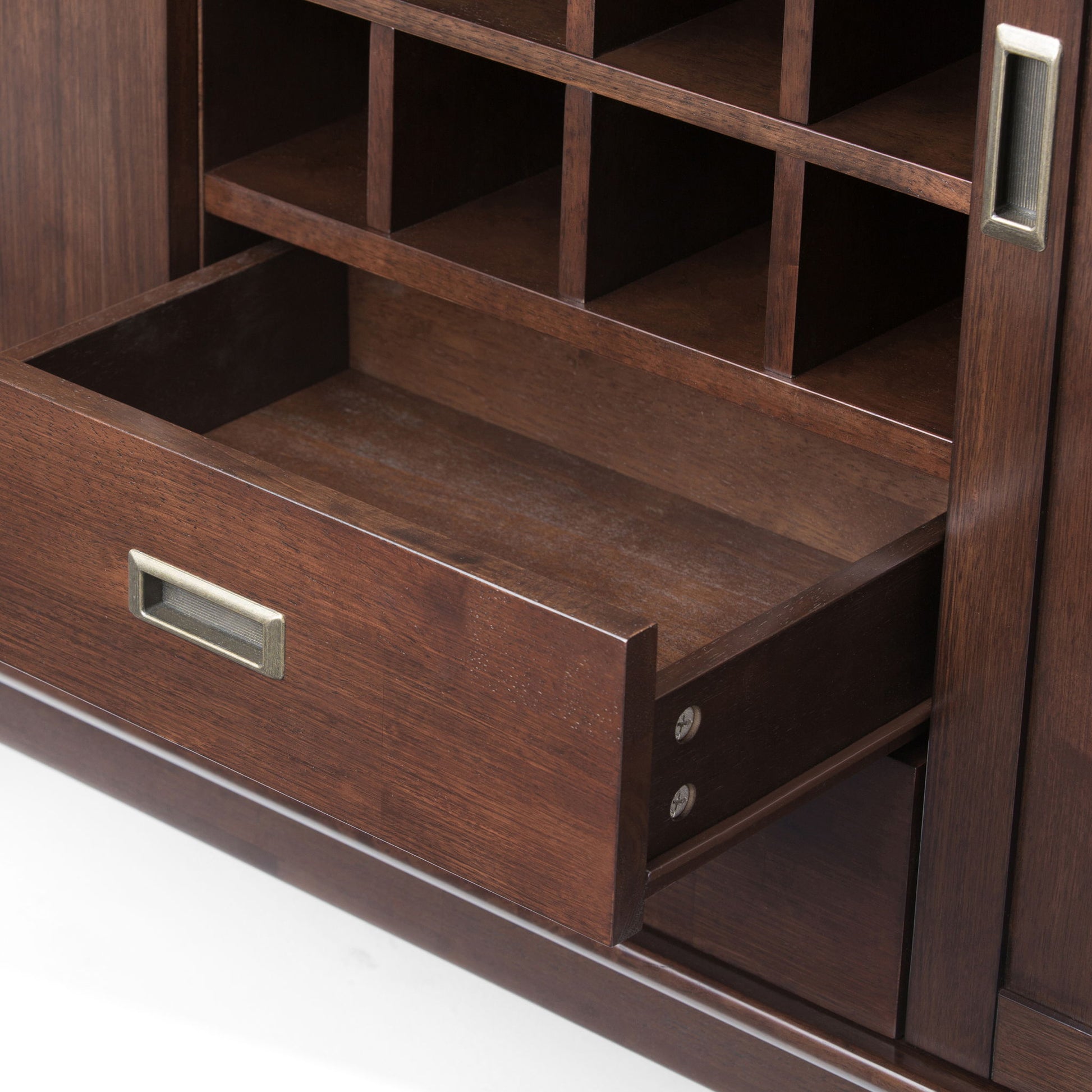 A close-up of the Draper Mid Century Sideboard Buffet and Wine Rack in medium auburn brown, featuring an open drawer, metallic handles, and several empty square cubbyholes above it.