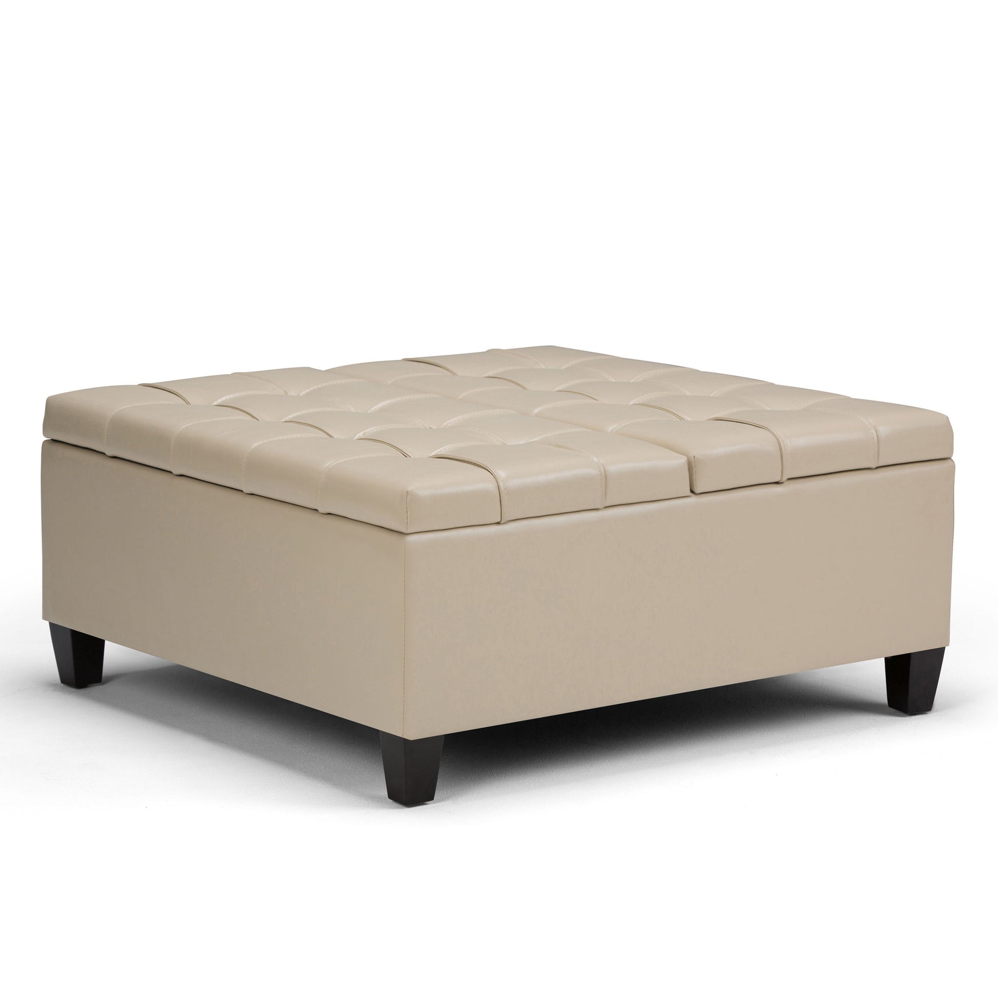 The Harrison - Upholstered Coffee Table Storage Ottoman is a large, square beige ottoman with a tufted top and short dark wooden legs, shown on a white background.