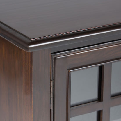 Close-up of the upper corner of the Connaught Tall Storage Cabinet in Dark Chestnut Brown, featuring a glass-paneled door and decorative trim along the top edge.