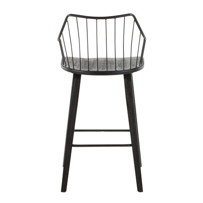 The Winston - Farmhouse Counter Stool features a modern black design with a curved open wire backrest and four angled wooden legs joined by a metal footrest.