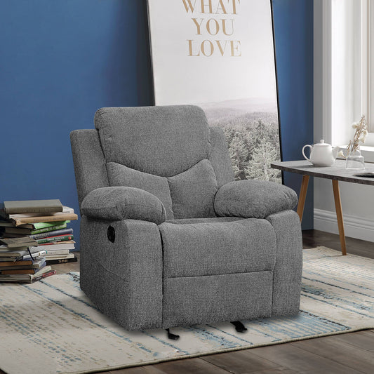 The Kalen - Chenille Glider Recliner in gray sits on a blue and beige rug in a cozy living room with blue walls, stacked books, a side table with a teapot and cup, and framed art that says "WHAT YOU LOVE.