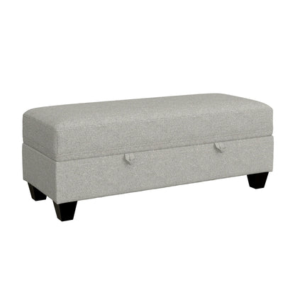 The Drason Storage Ottoman is a rectangular, light gray upholstered bench with black wooden legs and two fabric pull handles on the front for easy access to storage.