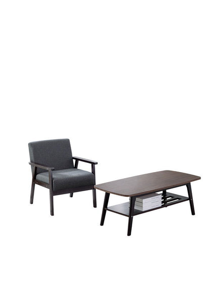 The Bahamas - Coffee Table And Chair (Set of 2) features a dark wooden coffee table with a lower shelf for books and a matching armchair with dark gray cushions, set against a white background.