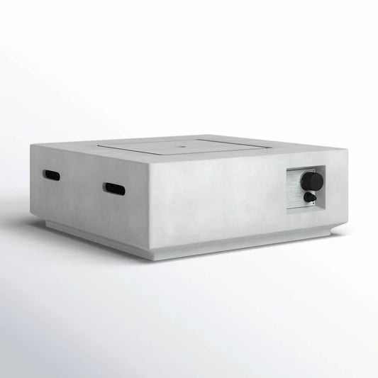 The Reinforced - Propane / Gas Fire Pit Table is a minimalist rectangular concrete tabletop fire pit with smooth edges, side vent slots, and a metallic control knob on the front right corner, shown against a plain white background.