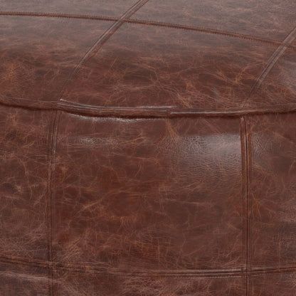 Close-up of the Connor Handcrafted Round Pouf, featuring brown leather upholstery with visible stitching and natural texture.