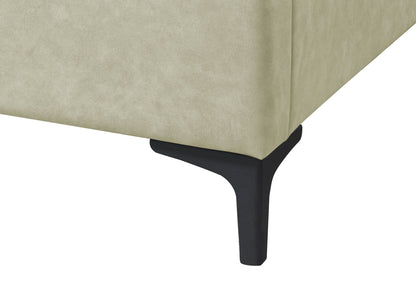 Close-up of the corner of a Fully Upholstered Bed in light beige with a black, modern, angled metal leg.