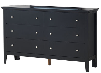 The Primo - Dresser features a sleek black finish, six drawers with silver round knobs, four legs plus a center support leg. Its modern design includes a smooth, flat top surface for a simple yet stylish look.