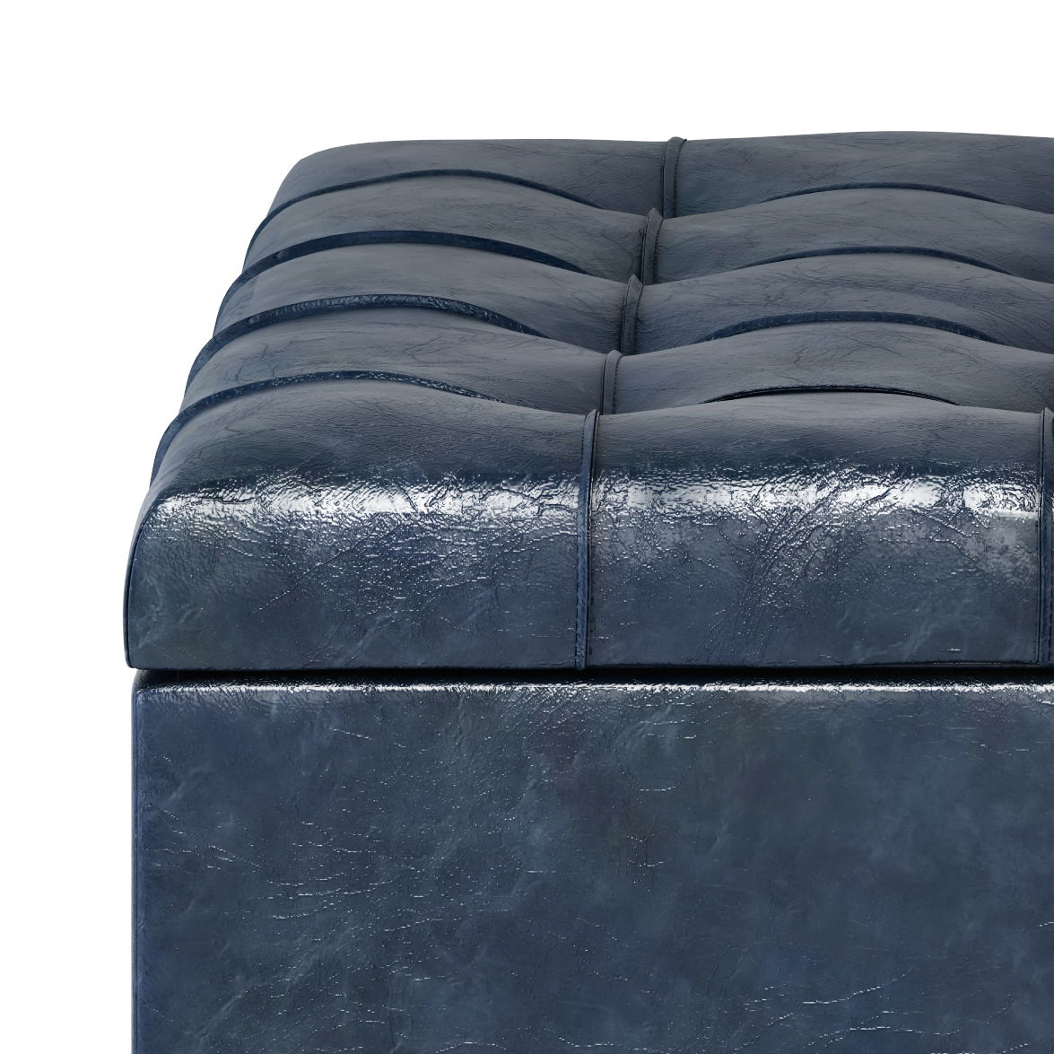 Close-up of the Harrison - Upholstered Coffee Table Storage Ottoman in dark blue leather, featuring a tufted, square-stitched cushioned top with a textured surface.