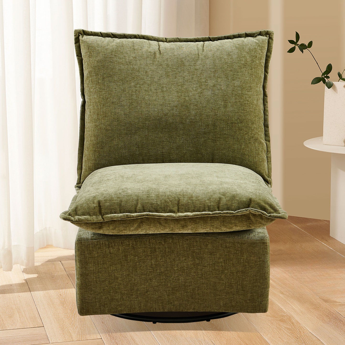 The Detachable Chenille Single 360 Swivel Rocking Rocker offers plush comfort in a green armless design, set on a wooden floor with beige walls, white curtains, and a round table with a potted plant in the background.