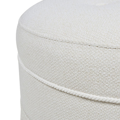 Close-up of the Yolanda - Round Upholstered Accent Ottoman in light beige, featuring a textured weave, two horizontal decorative seams around the side, soft upholstery, and neat stitching.