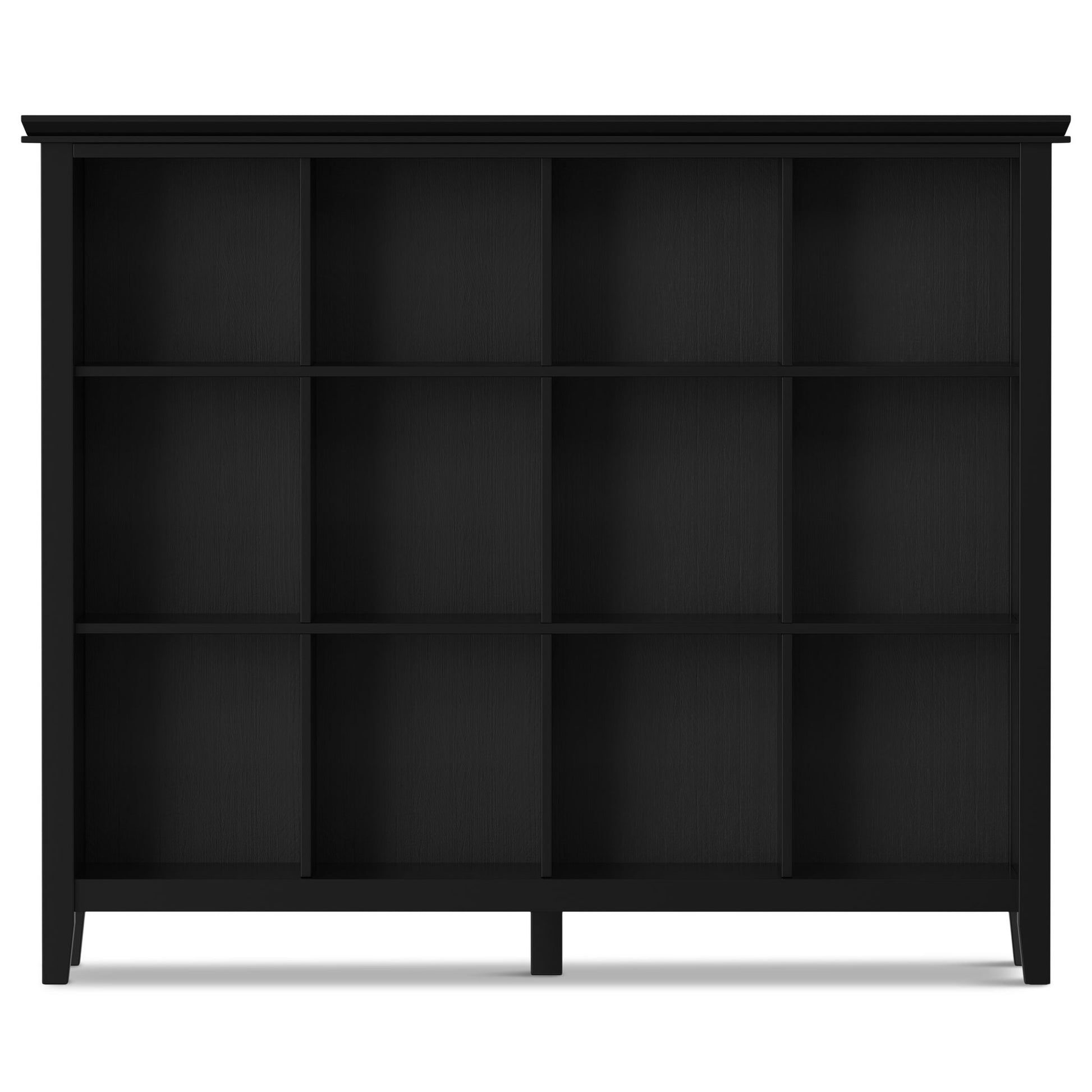 The Artisan - Cube Storage is a black wooden bookshelf featuring twelve square compartments in a 3-by-4 grid, set on four short legs and displayed against a plain white background.