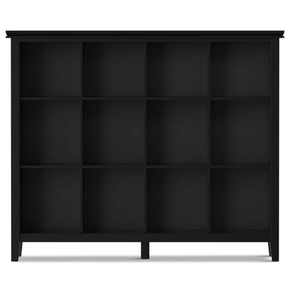 The Artisan - Cube Storage is a black wooden bookshelf featuring twelve square compartments in a 3-by-4 grid, set on four short legs and displayed against a plain white background.