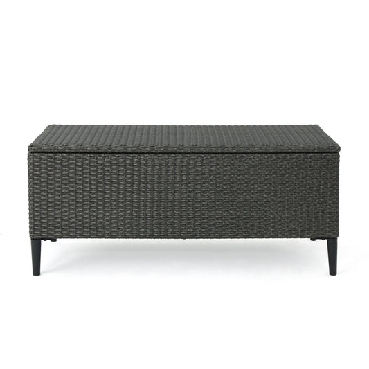 The Rupert Storage Unit is a rectangular outdoor box made of dark resin wicker with four black tapered legs, shown on a white background.