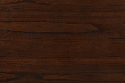 Close-up of the Graham dining table's dark brown wooden surface reveals its grain patterns and natural color variations, offering both texture and modern functionality with USB charging ports and shelves.