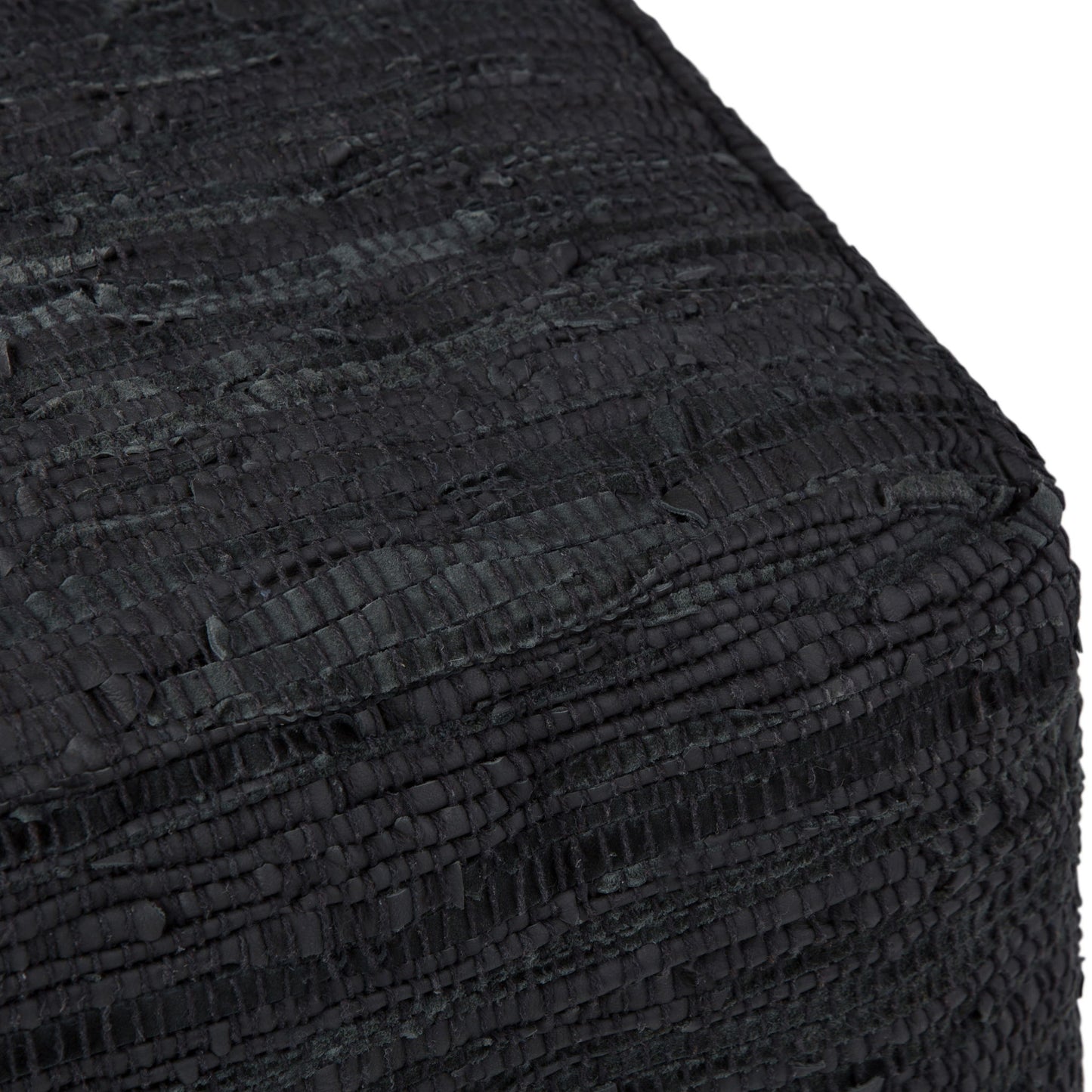 Close-up of the corner of the Fredrik - Handcrafted Square Pouf, highlighting its textured black fabric and woven, ridged pattern.